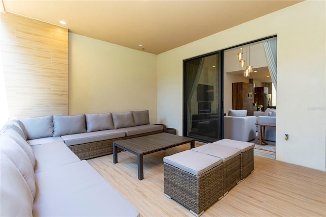 living room with an inviting chandelier and light hardwood / wood-style floors