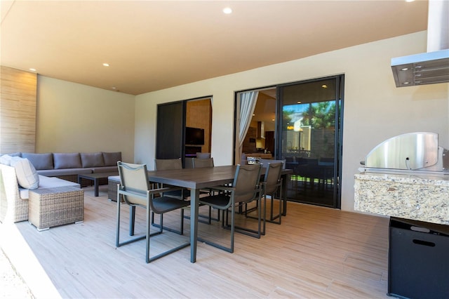 dining space with hardwood / wood-style flooring