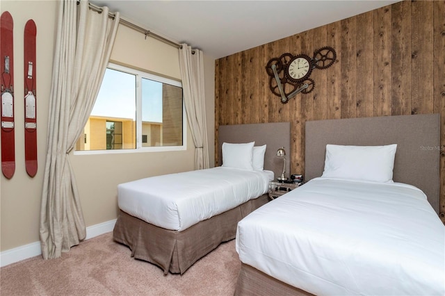 carpeted bedroom with wood walls