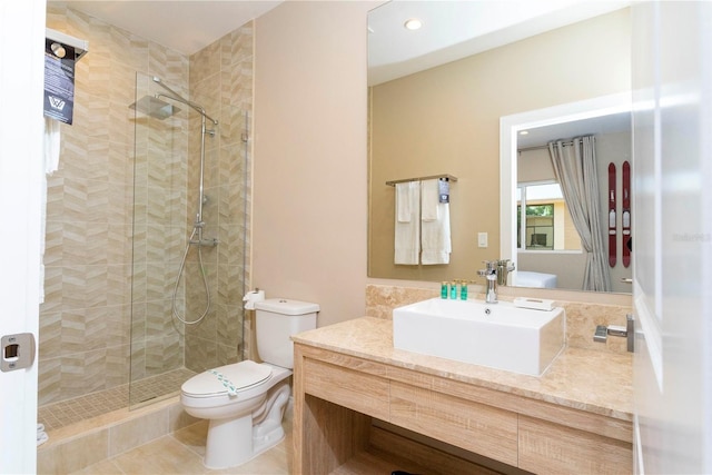 bathroom featuring tile patterned flooring, vanity, toilet, and a shower with shower door