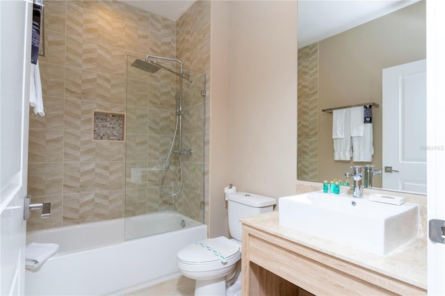 full bathroom featuring vanity, toilet, and tiled shower / bath combo