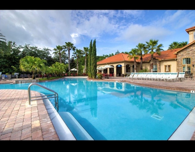 view of swimming pool with a patio area