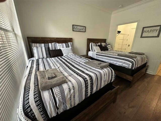 bedroom featuring ornamental molding and hardwood / wood-style flooring