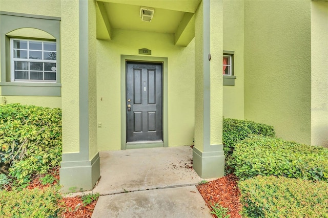 view of exterior entry with stucco siding