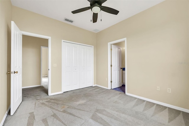 unfurnished bedroom featuring a ceiling fan, visible vents, baseboards, a closet, and carpet