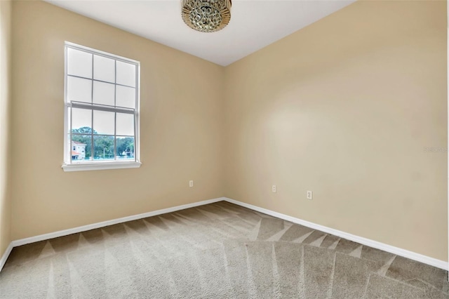 empty room with carpet flooring and baseboards