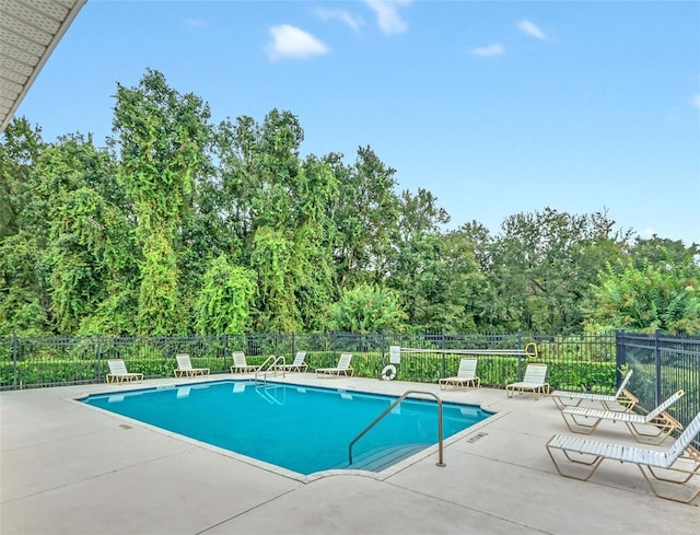 pool featuring fence and a patio