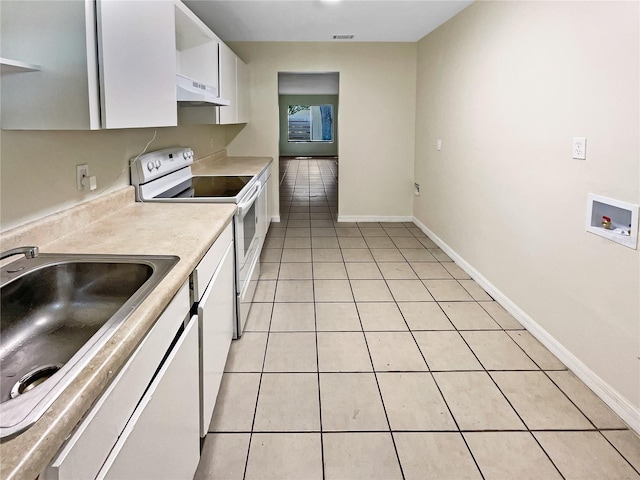 kitchen featuring light tile patterned floors, under cabinet range hood, white cabinets, light countertops, and white range with electric cooktop