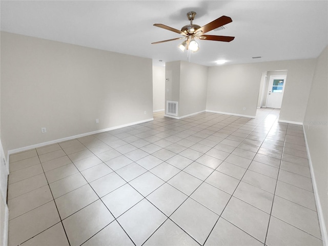 empty room with a ceiling fan, visible vents, and baseboards