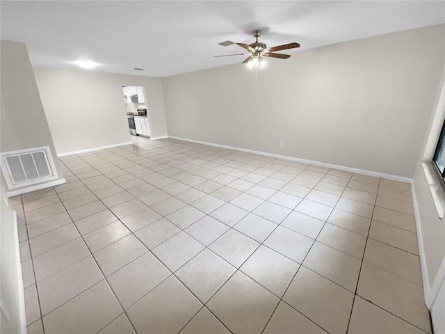 unfurnished room with ceiling fan, visible vents, and baseboards