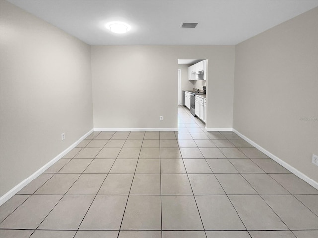 spare room featuring visible vents, baseboards, and light tile patterned floors