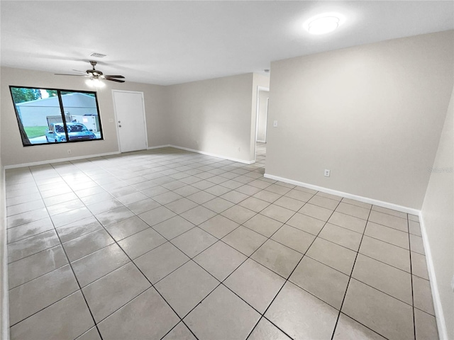 empty room with visible vents, baseboards, and a ceiling fan