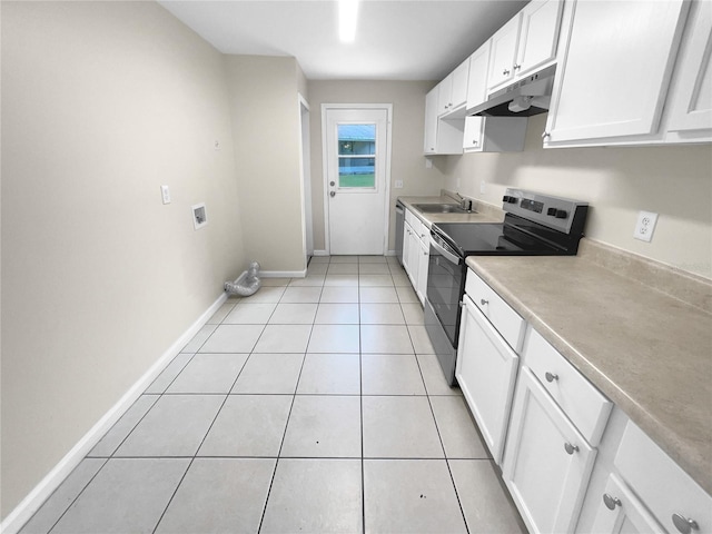 kitchen with under cabinet range hood, stainless steel appliances, a sink, baseboards, and white cabinets