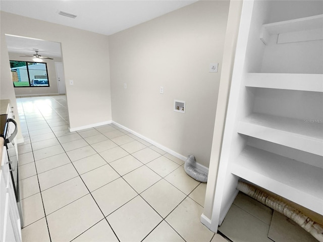 washroom with light tile patterned floors, hookup for a washing machine, visible vents, and baseboards