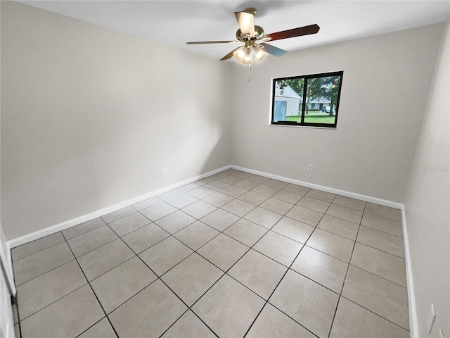 unfurnished room featuring baseboards and a ceiling fan