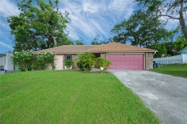 ranch-style house featuring a garage and a front lawn