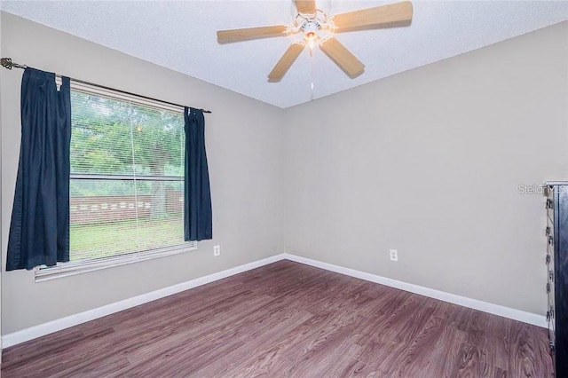 empty room featuring a textured ceiling, ceiling fan, and wood-type flooring