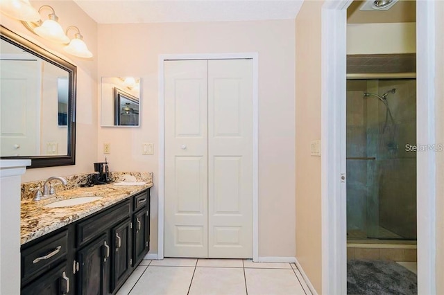 bathroom featuring vanity, an enclosed shower, and tile patterned floors