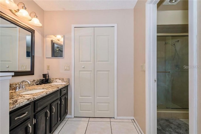 bathroom featuring tile patterned floors, walk in shower, and vanity