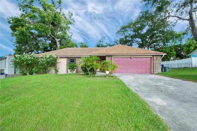 ranch-style home with a front lawn and a garage