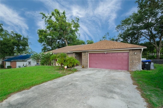 view of front of home with a garage and a front lawn