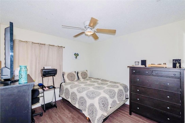 bedroom featuring a textured ceiling, ceiling fan, and dark hardwood / wood-style flooring