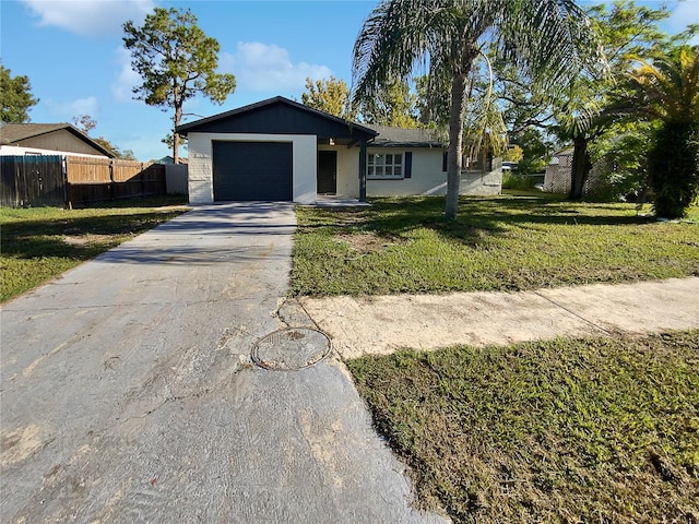 single story home featuring a garage and a front lawn