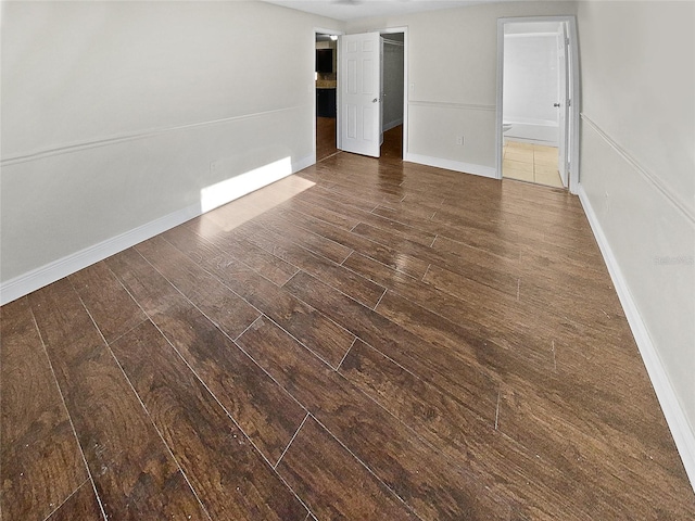 empty room with dark wood-type flooring