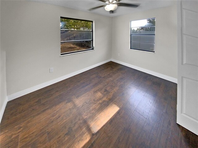 spare room featuring ceiling fan and dark hardwood / wood-style floors