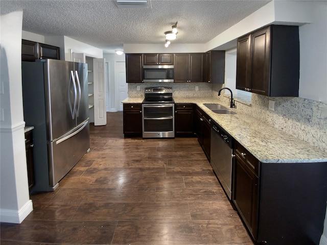 kitchen featuring dark hardwood / wood-style flooring, tasteful backsplash, stainless steel appliances, sink, and dark brown cabinetry