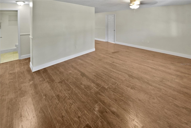 unfurnished room featuring ceiling fan and dark hardwood / wood-style flooring