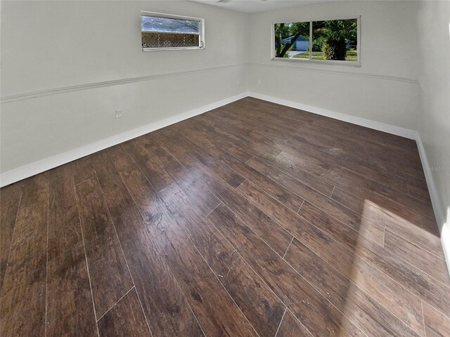 unfurnished room featuring dark wood-type flooring