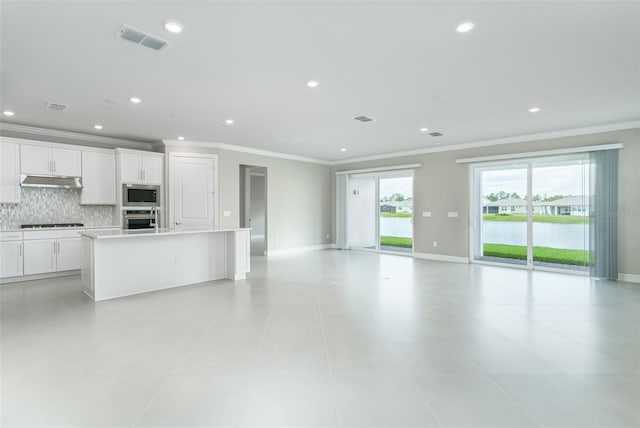 unfurnished living room with ornamental molding and light tile patterned floors