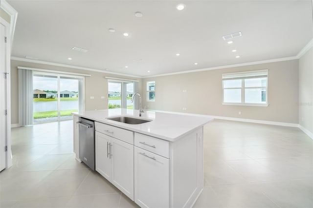 kitchen featuring white cabinets, light tile patterned floors, a kitchen island with sink, and sink