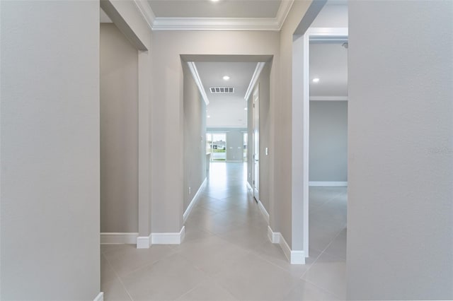 hall featuring ornamental molding and light tile patterned floors