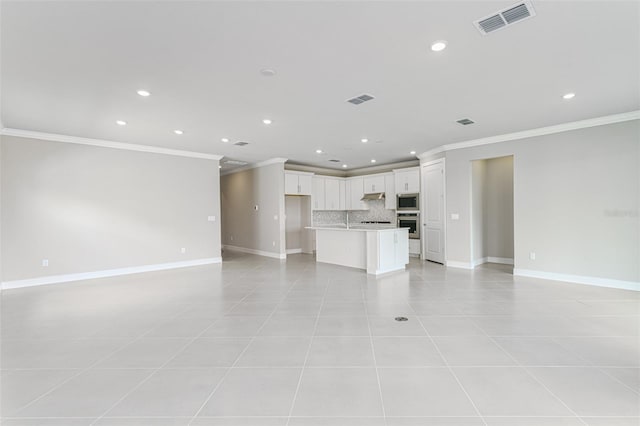 unfurnished living room featuring light tile patterned floors, sink, and ornamental molding