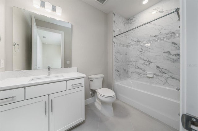 full bathroom featuring vanity, tiled shower / bath, tile patterned floors, and toilet