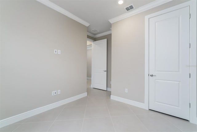 unfurnished bedroom with light tile patterned floors and ornamental molding