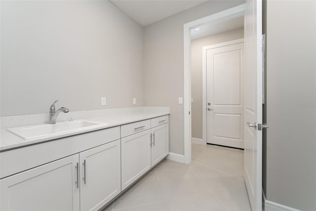 bathroom with tile patterned floors and vanity