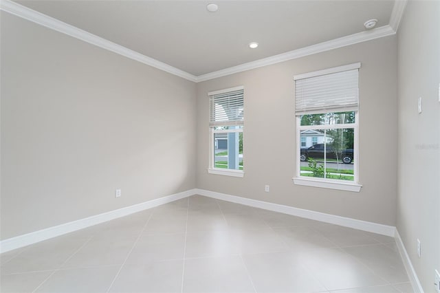 spare room featuring ornamental molding and light tile patterned flooring