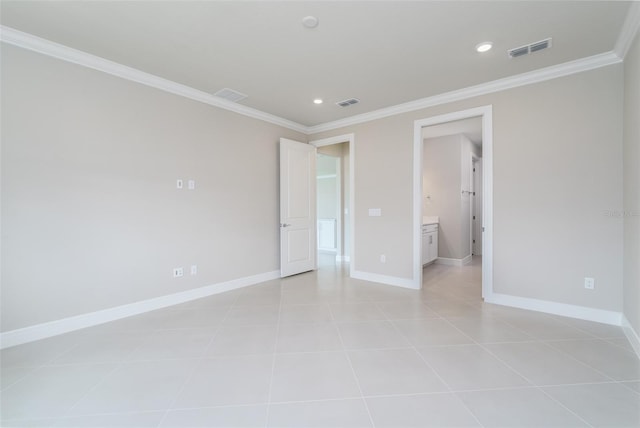 tiled spare room featuring ornamental molding