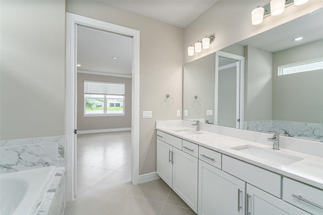 bathroom with tile patterned floors, tiled tub, and vanity