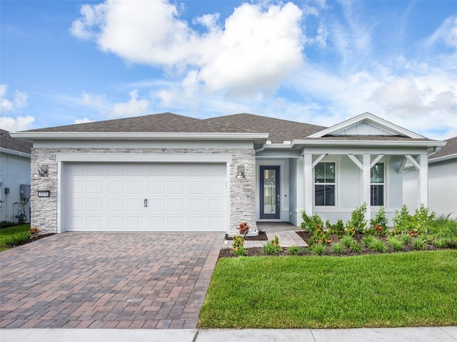 view of front of house featuring a garage and a front lawn