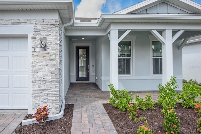 property entrance with a garage and covered porch