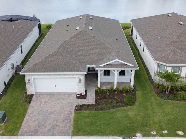 view of front of home featuring a front lawn and central AC