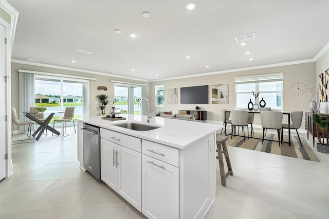 kitchen with sink, white cabinets, an island with sink, and a healthy amount of sunlight