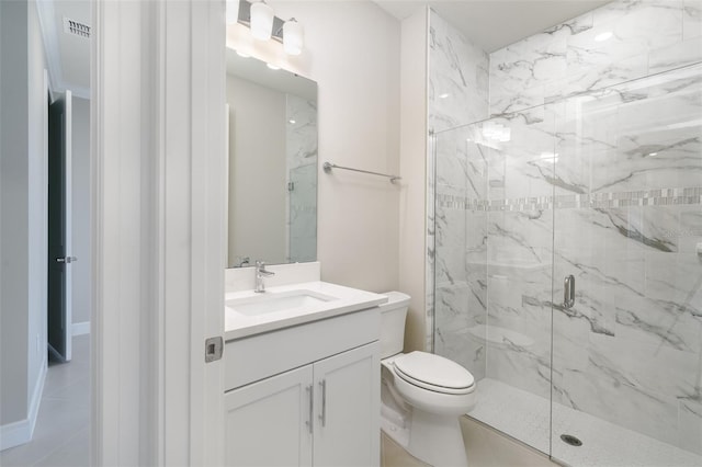 bathroom featuring vanity, toilet, an enclosed shower, and tile patterned floors