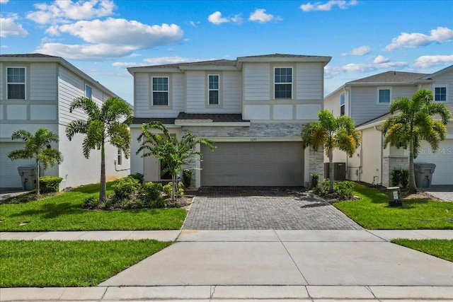 view of front of property with a garage and central AC