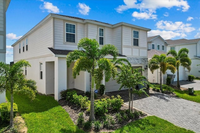 view of front of house featuring a front yard and a garage