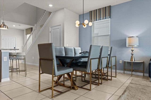 dining room with a chandelier, a high ceiling, and light tile patterned floors